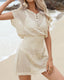 Plus size crochet mesh beach cover-up with buttoned V-neck, short sleeves, and waist-cinching design in lightweight acrylic