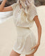Plus size crochet mesh beach cover-up with buttoned V-neck, short sleeves, and waist-cinching design in lightweight acrylic