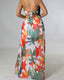 Chiffon maxi beach dress with halter neckline, ditsy floral print, split thigh, and tie-back with chain and ring details