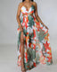 Chiffon maxi beach dress with halter neckline, ditsy floral print, split thigh, and tie-back with chain and ring details