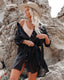 Long sleeve loose-fit beach cover-up with lapel collar and see-through fabric, ideal for swimwear layering and summer versatility