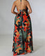Chiffon maxi beach dress with halter neckline, ditsy floral print, split thigh, and tie-back with chain and ring details